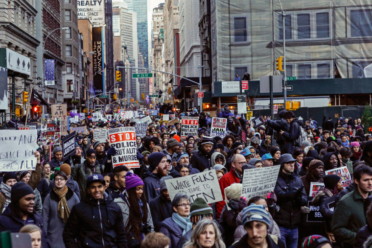 People march against police violence in Midtown Manhattan, New York December 13, 2014. Thousands marched in Washington, New York and Boston on Saturday to protest killings of unarmed black men by police officers.