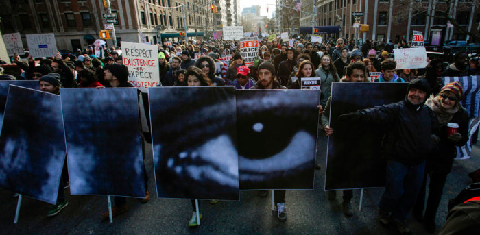 People take part in a march against police violence, in New York December 13, 2014. Thousands of demonstrators gathered in Washington on Saturday for a march to protest the killings of unarmed black men by law enforcement officers and to urge Congress to do more to protect African-Americans from unjustified police violence. Organizers said the event and the parallel march in New York City would rank among the largest in the recent wave of protests against the killings of black males by officers in Ferguson, Missouri, New York, Cleveland and elsewhere.