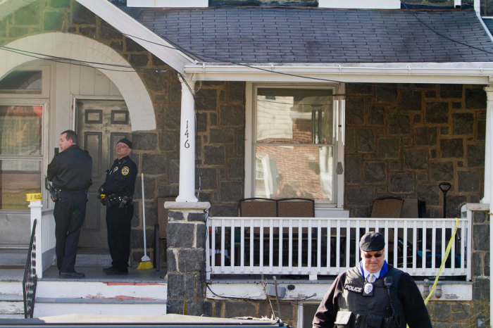 Police search outside a home in a suburb of Philadelphia where a suspect in five killings was believed to be barricaded in Souderton, Pennsylvania, December 15, 2014. The unidentified suspect, who is believed to be a military veteran, is suspected in connection with the slayings of five people, all shot at close range, in three separate suburbs northwest of Philadelphia, WPVI television and other media reported.