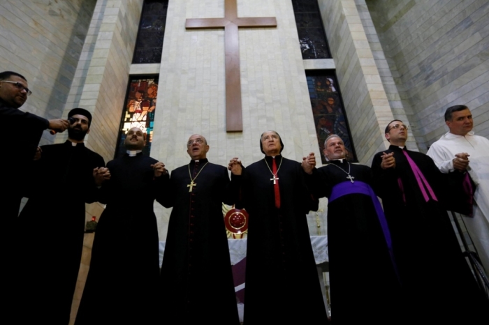 Priests offer prayers during a service for around 600 Iraqi Christian refugees at a church in Hazmiyeh, near Beirut, December 12, 2014. Iraqi Christians who sought refuge in Lebanon after Islamist militants tore through their homeland said they had no idea when they would be able to return as they gathered for prayers ahead of Christmas.