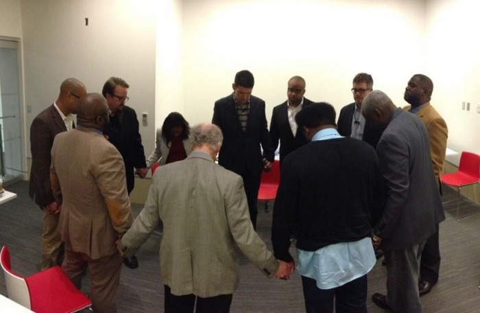 Eleven leaders, including event organizer Pastor Bryan Loritts, theologian John Piper, and pastors Matt Chandler, Darrin Patrick, and Derwin Gray pray before 'A Time to Speak' a panel discussion at the historic Lorraine Motel and National Civil Rights Museum in Memphis, Dec. 16, 2014.