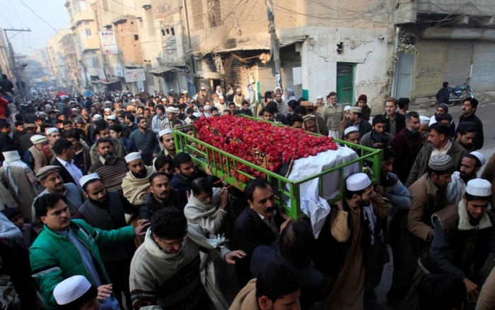 People carry the coffin of a male student who was killed in Tuesday's attack on the Army Public School, which was attacked by Taliban gunmen, during his funeral in Peshawar, December 17, 2014. At least 132 students and nine staff members were killed on Tuesday when Taliban gunmen broke into the school and opened fire, witnesses said, in the bloodiest massacre the country has seen for years.