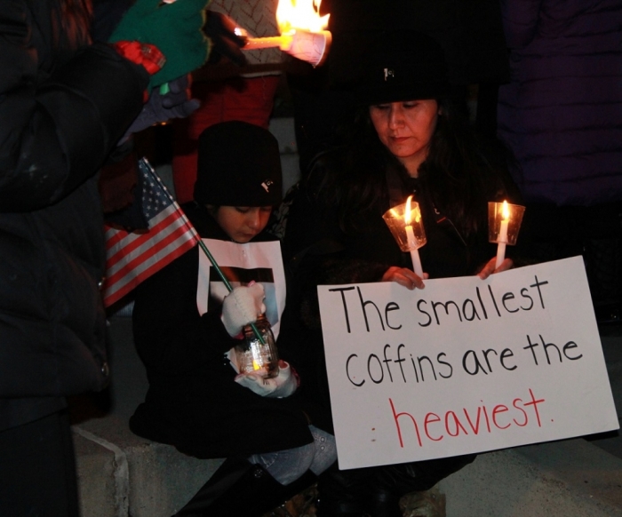 People gather at the Dupont Circle fountain in Washington, D.C. for a vigil in remembrance of the more than 140 people killed in a terrorist attack at the military-run Army Public School in Peshawar, Pakistan. The vigil was held Wednesday, December 17, 2014.