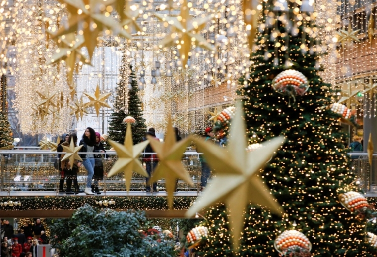 People walk in a shopping mall decorated with Christmas lights in Berlin, Germany, December 19, 2014.