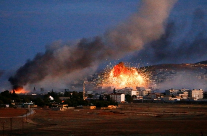 Smoke and flames rise over Syrian town of Kobani after an airstrike, as seen from the Mursitpinar crossing on the Turkish-Syrian border in the southeastern town of Suruc in Sanliurfa province, October 20, 2014. The United States told Turkey that a U.S. military air-drop of arms to Syrian Kurds battling Islamic State near the Syrian town of Kobani was a response to a crisis situation and did not represent a change in U.S. policy, U.S. Secretary of State John Kerry said on Monday.