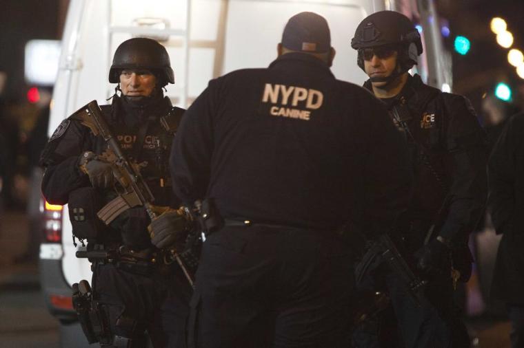 Policemen are pictured at the scene of a shooting where two New York Police officers were shot dead in the Brooklyn borough of New York, December 20, 2014.