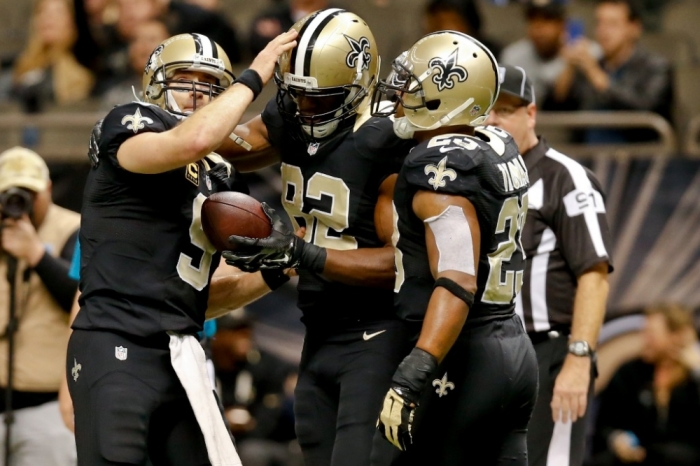 New Orleans Saints quarterback Drew Brees (9) celebrates a touchdown to tight end Benjamin Watson (82) during the second half of a game at the Mercedes-Benz Superdome. The Panthers defeated the Saints 41-10, New Orleans, Louisiana, December 7, 2014.