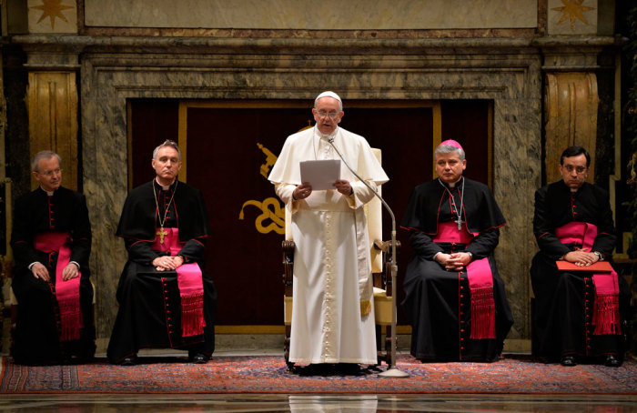 Pope Francis talks during an audience for Christmas greetings to the Curia in the Clementina hall at the Vatican December 22, 2014
