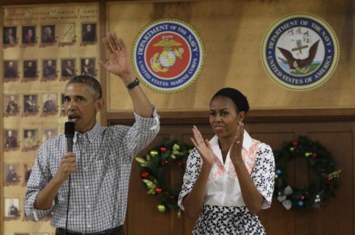 U.S. President Barack Obama and First Lady Michelle Obama (R) greet U.S. military personnel at Marine Corps Base Hawaii on Christmas Day in Kaneohe Bay, Hawaii December 25, 2014.