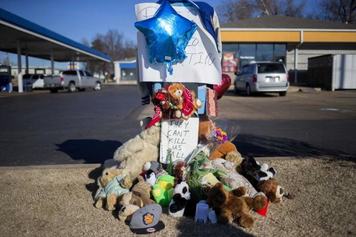 A memorial to Antonio Martin, an armed 18-year-old who was fatally shot by police late Tuesday, is seen in Berkeley, Missouri, December 25, 2014.