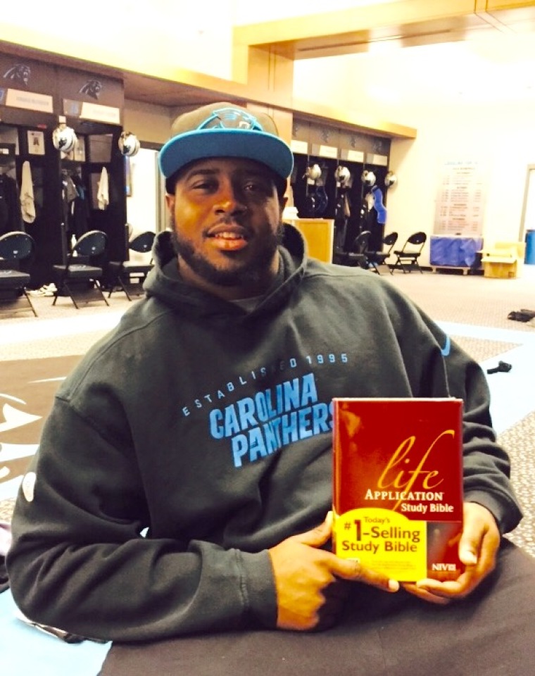Kawann Short participates in Athletes for Charity's Bible giveaway.