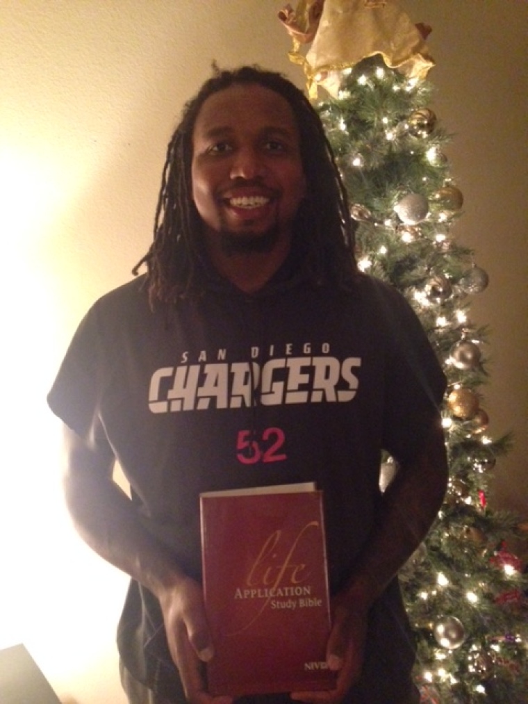 Reggie Walker participates in Athletes for Charity's Bible giveaway.