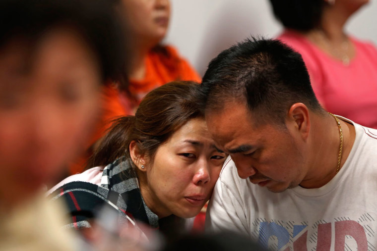 Family of passengers onboard AirAsia flight QZ8501 react at a waiting area in Juanda International Airport, Surabaya December 28, 2014. Indonesia's air force was searching for the AirAsia plane carrying 162 people that went missing on Sunday after the pilots asked to change course to avoid bad weather during a flight from the Indonesian city of Surabaya to Singapore. The Airbus 320-200 lost contact with Jakarta air traffic control at 6:17 a.m. (2317 GMT), officials said.