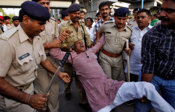A member of India's lowest caste 'Dalits' shouts slogans as he is detained by police during a demonstration in the western Indian city of Ahmedabad, April 27, 2014. 