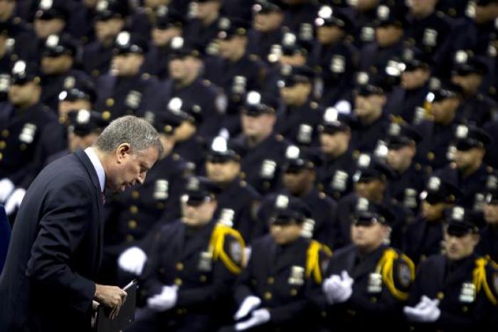 New York Mayor Bill de Blasio walks away from the podium after speaking to the New York City Police Academy graduating class in New York, December 29, 2014.