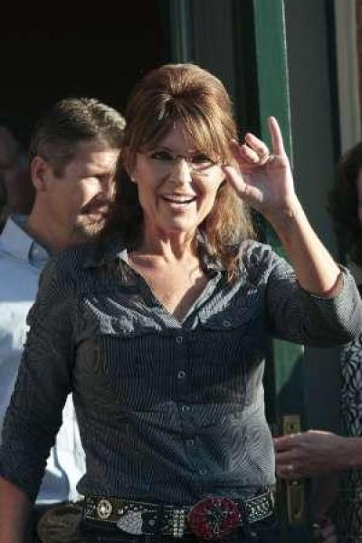 Former Alaska Gov. Sarah Palin waves to supporters following the premiere of a documentary about her entitled 'The Undefeated' in Pella, Iowa, June 28, 2011.