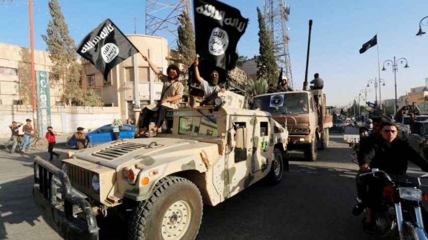 Militant Islamist fighters take part in a military parade along the streets of Syria's northern Raqqa province, June 30, 2014. The fighters held the parade to celebrate their declaration of an Islamic