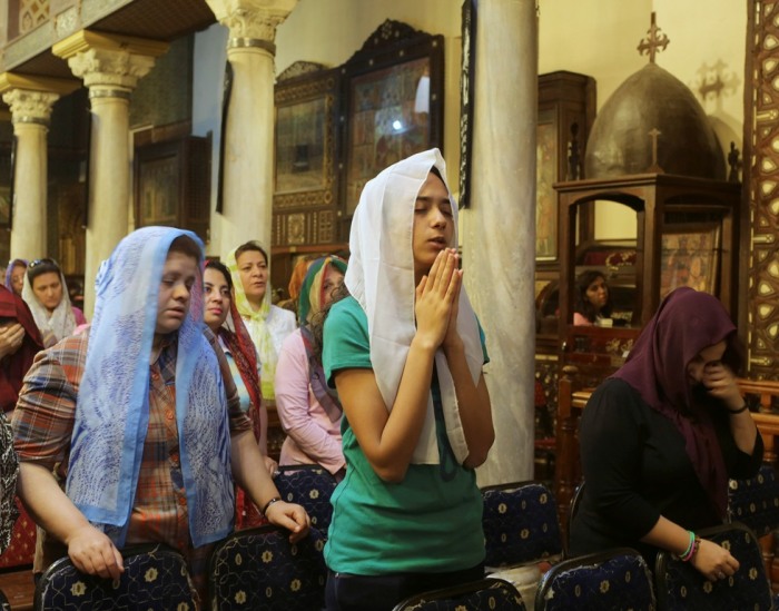 Coptic Christians attend a church service during Holy Easter week in central Cairo, Egypt, April 17, 2014.