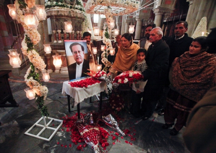 Pakistani Christians place flowers at a portrait of the assassinated Governor of Punjab Salman Taseer after a Sunday service at the Cathedral Church of the Resurrection in Lahore, January 9, 2011. Taseer was shot dead by one of his guards, who was apparently incensed by the politician's opposition to the blasphemy law, in Islamabad on January 4, 2011.