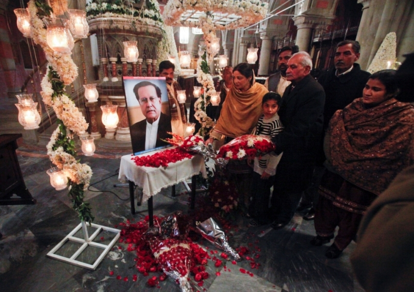 Pakistani Christians place flowers at a portrait of the assassinated Governor of Punjab Salman Taseer after a Sunday service at the Cathedral Church of the Resurrection in Lahore, January 9, 2011. Taseer was shot dead by one of his guards, who was apparently incensed by the politician's opposition to the blasphemy law, in Islamabad on January 4, 2011.