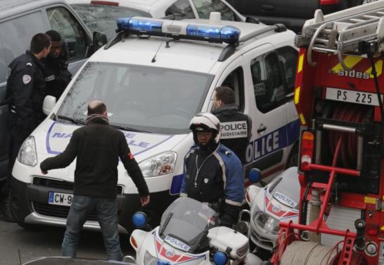 Policemen work at the scene after a shooting at the Paris offices of Charlie Hebdo, a satirical newspaper, January 7, 2015.