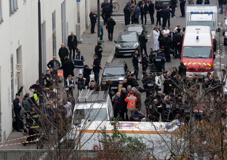 General view of police and rescue vehicles at the scene after a shooting at the Paris offices of Charlie Hebdo, a satirical newspaper, January 7, 2015. Eleven people were killed and 10 injured in shooting at the Paris offices of the satirical weekly Charlie Hebdo, already the target of a firebombing in 2011 after publishing cartoons deriding Prophet Mohammad on its cover, police spokesman said. Five of the injured were in a critical condition, said the spokesman. Separately, the government said it was raising France's national security level to the highest notch.