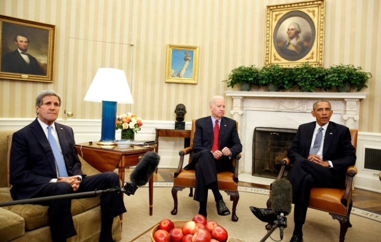 U.S. President Barack Obama (R) is joined by Vice President Joseph Biden (C) and Secretary of State John Kerry, as he makes a statement about the mass shooting in Paris, while in the Oval Office at the White House in Washington, January 7, 2015. Obama on Wednesday condemned the deadly shooting at a magazine office in Paris on Wednesday, calling it a terrorist attack against its ally, France.