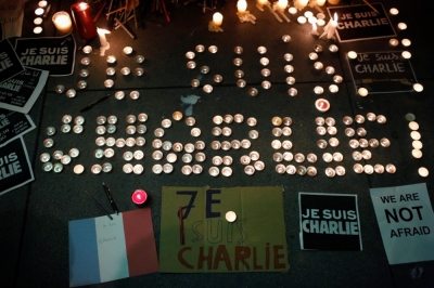 A makeshift memorial is seen outside the Consulate General of France during a vigil for the victims of an attack on satirical magazine Charlie Hebdo in Paris, in San Francisco, California, January 7, 2015. The youngest of three French nationals being sought by police for a suspected Islamist militant attack that killed 12 people at a satirical magazine on Wednesday turned himself in to the police, an official at the Paris prosecutor's office said. The hooded attackers stormed the Paris offices of Charlie Hebdo, a weekly known for lampooning Islam and other religions, in the most deadly militant attack on French soil in decades.