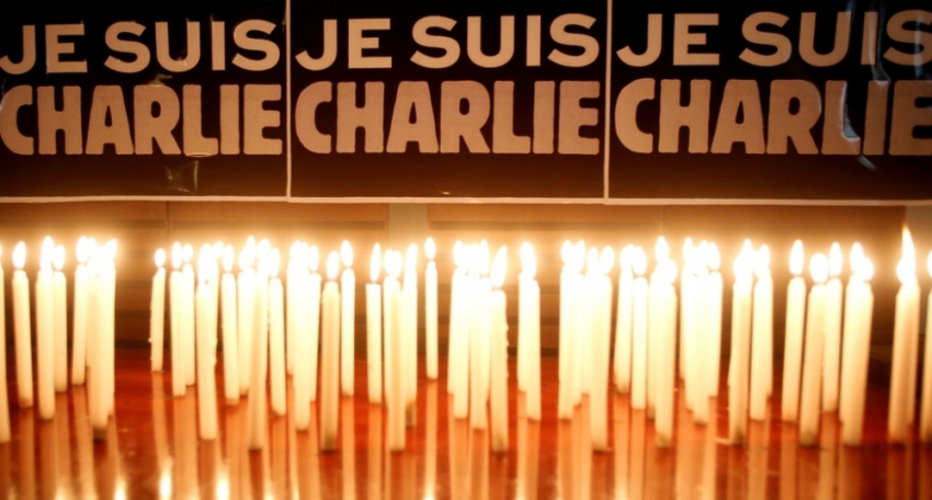 Candles are seen in front of a banner that reads "I am Charlie" during a minute of silence for victims of the shooting at the Paris offices of weekly newspaper Charlie Hebdo on Wednesday, at the French Embassy in Hanoi, Vietnam, January 8, 2015. France began a day of mourning for the journalists and police officers shot dead on Wednesday morning by black-hooded gunmen using Kalashnikov assault rifles.