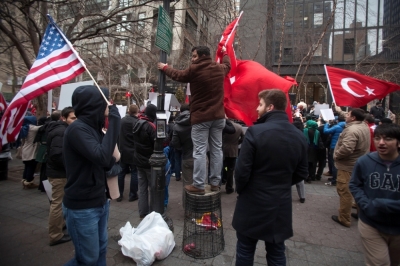 A protester stands on a upturned garbage can as he takes part in a protest against the Turkish Government for issuing an arrest warrant for U.S.-based Muslim cleric Fethullah Gulen in the Manhattan borough of New York, December 20, 2014. A Turkish court issued an arrest warrant on Friday for the U.S.-based Muslim cleric whose followers are accused by President Tayyip Erdogan of leading a terrorist plot to seize power, according to media.