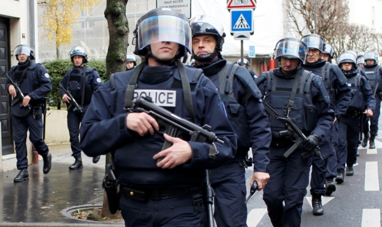 French intervention police take up position near the scene of a hostage taking at a kosher supermarket in eastern Paris, January 9, 2015, following Wednesday's deadly attack at the Paris offices of weekly satirical newspaper Charlie Hebdo by two masked gunmen who shouted Islamist slogans. Several people were taken hostage at a kosher supermarket in eastern Paris on Friday after a shootout involving a man armed with two guns, a police source said. There were unconfirmed local media reports that the man was the same as the one suspected of killing a policewoman in Montrouge, a southern suburb of Paris on Thursday.