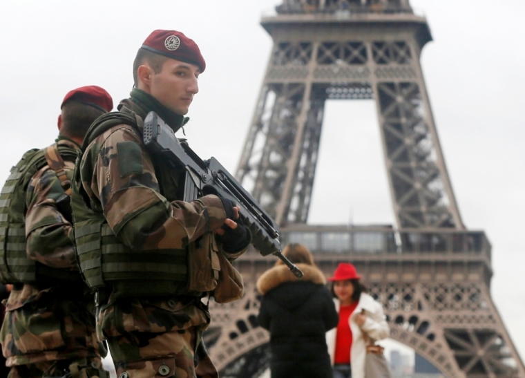 French soldier patrol near the Eiffel Tower in Paris as part of the highest level of 'Vigipirate' security plan after a shooting at the Paris offices of Charlie Hebdo, January 9, 2015. The two main suspects in the weekly satirical newspaper Charlie Hebdo killings were sighted on Friday in the northern French town of Dammartin-en-Goele where at least one person had been taken hostage, a police source said.