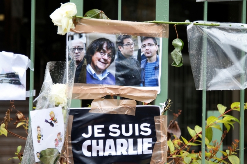 Pictures of cartoonists Georges Wolinski, Cabu, Tignous and Charb and a placard which reads "I am Charlie" are displayed at the scene where a policeman was killed after the deadly attack at the Paris offices of weekly satirical newspaper Charlie Hebdo in Paris, January 9, 2015. The two main suspects in the weekly satirical newspaper Charlie Hebdo killings were sighted on Friday in the northern French town of Dammartin-en-Goele where at least one person had been taken hostage, a police source said.