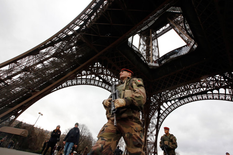 A French soldier patrols near the Eiffel Tower as part of the highest level of 'Vigipirate' security plan after a shooting at the Paris offices of Charlie Hebdo January 10, 2015. French police searched for a female accomplice to militant Islamists behind deadly attacks on the satirical Charlie Hebdo weekly newspaper and a kosher supermarket and maintained a top-level anti-terrorist alert ahead of a Paris gathering with European leaders and demonstration set for Sunday. In the worst assault on France's homeland security for decades, 17 victims lost their lives in three days of violence that began with an attack on the Charlie Hebdo weekly on Wednesday and ended with Friday's dual hostage-taking at a print works outside Paris and kosher supermarket in the city.