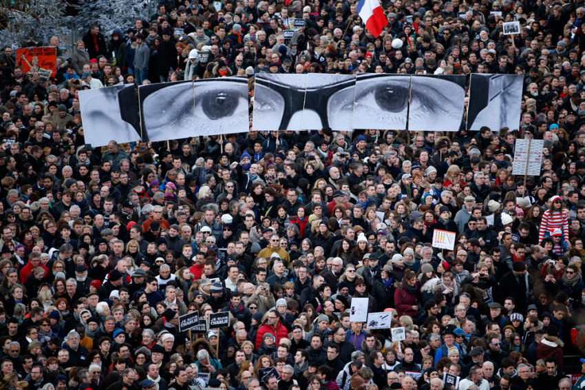 People hold panels to create the eyes of late Charlie Hebdo editor Stephane Charbonnier, known as 
