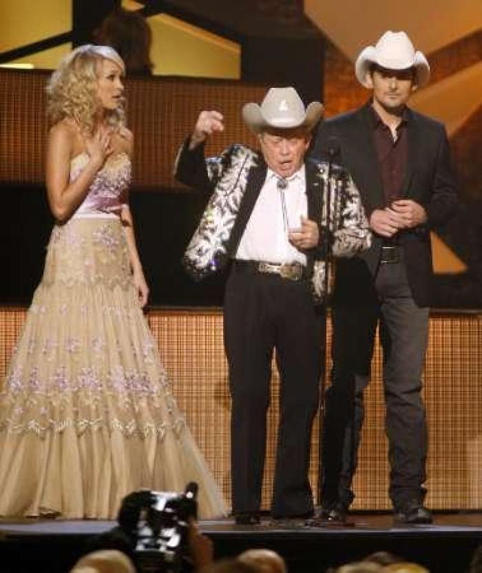 Little Jimmy Dickens (C) interrupts telecast hosts Brad Paisley and Carrie Underwood (L) at the 43rd annual Country Music Association Awards in Nashville November 11, 2009.