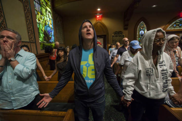 Worshippers at the Middle Collegiate Church hold prayer services wearing hoodies in support of slain teenager Trayvon Martin in response to the acquittal of George Zimmerman in his trial in New York, July 14, 2013.