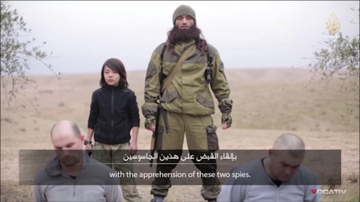 ISIS propaganda video released on Jan. 13, 2015 showing young boy executing two men.