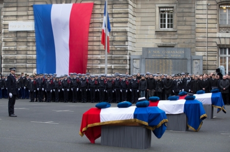 French Police officers pay respects to the three officers killed during last week's attacks by Islamic militants as they attend a national tribute at Paris Prefecture, January 13, 2015. The three police officers were killed in the terror attacks at the offices of satirical weekly Charlie Hebdo and in the streets of Montrouge, outside the French capital.