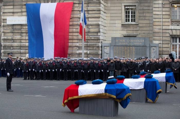French Police officers pay respects to the three officers killed during last week's attacks by Islamic militants as they attend a national tribute at Paris Prefecture, January 13, 2015. The three police officers were killed in the terror attacks at the offices of satirical weekly Charlie Hebdo and in the streets of Montrouge, outside the French capital.