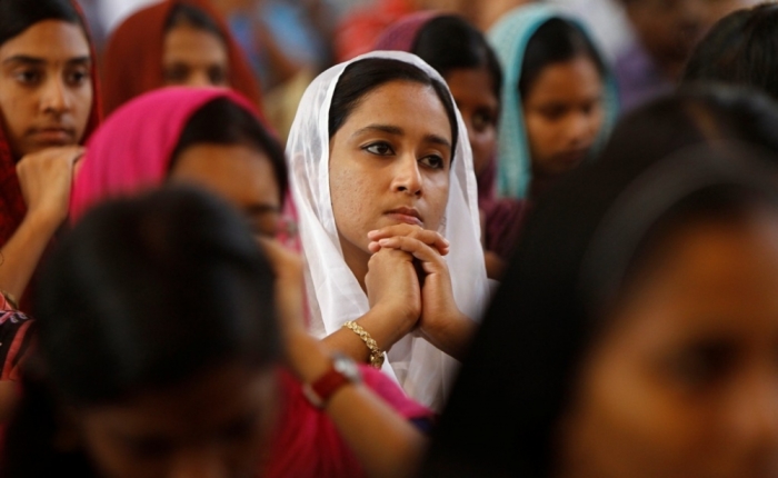 Women attend a mass inside a church to celebrate Easter in the southern Indian city of Chennai March 31, 2013. Holy Week is celebrated in many Christian traditions during the week before Easter.