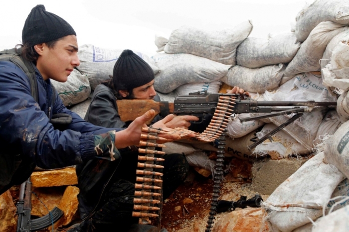 Rebel fighters fire a weapon on the al-Breij frontline, after what they said was an advance by them in the Manasher al-Hajr area where the forces of Syria's President Bashar al-Assad were stationed, in Aleppo, January 7, 2015.