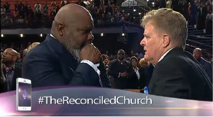 T.D. Jakes, senior pastor of The Potter's House megachurch in Dallas, Texas, (L) reacts to an apology from Jim Garlow, senior pastor of Skyline Church in San Diego, California, at the racial reconciliation summit held in Dallas, Texas, on January 15, 2015.