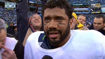 Seattle Seahawks quarterback Russell Wilson, 26, praises God after defeating the Green Bay Packers in the NFC Championship Game on Sunday Jan. 18, 2015.