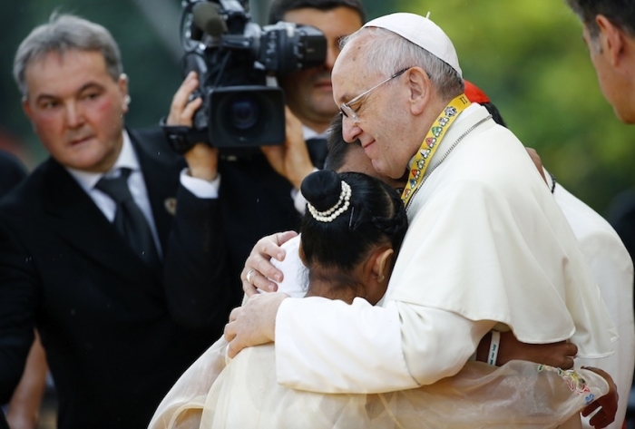 Pope Francis embraces a boy and a girl during a meeting with young people at Manila university, January 18, 2015.