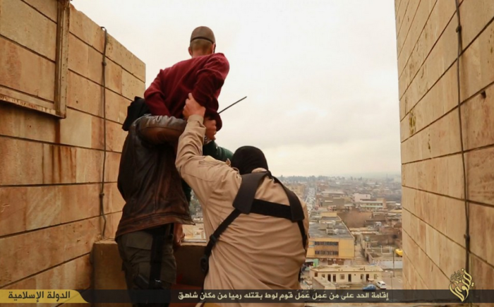 Militants from the Islamic State throw a man accused of committing a homosexual act off the roof of a tall building in Mosul, Iraq.