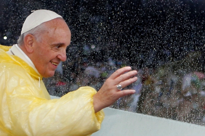 Pope Francis waves from the popemobile after leading a Mass at Rizal Park in Manila January 18, 2015. Huge crowds converged on a Manila park on Sunday to see Pope Francis wrap up his Asian trip with an outdoor Mass expected to draw one of the largest crowds in Philippine history.
