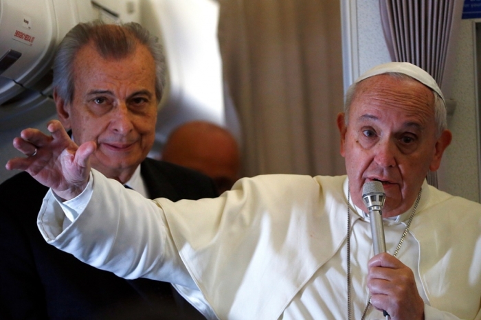 Pope Francis gestures as he speaks with journalists on his flight back from Manila to Rome, January 19, 2015.