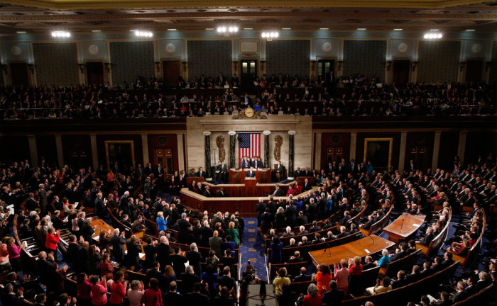 Democratic members of congress stand and applaud U.S. President Barack Obama (C) as he delivers his State of the Union address to a joint session of Congress in the U.S. Capitol in Washington January 20, 2015.