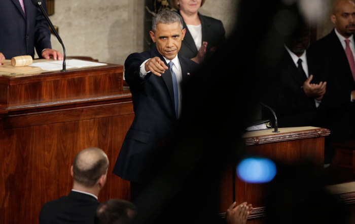 U.S. President Barack Obama points into the crowd of legislators on the floor near the start of his State of the Union address to a joint session of the U.S. Congress on Capitol Hill in Washington, January 20, 2015.